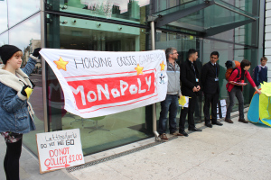 Renters hold a 'Housing crisis Monopoly' banner outside Foxtons